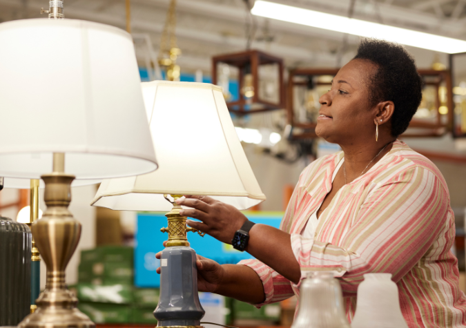 ReStore shopper looking at light fixtures.