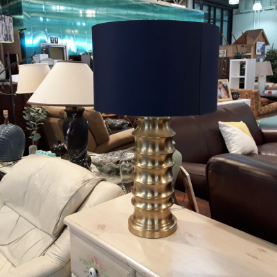 Modern, gold lamp with navy shade.